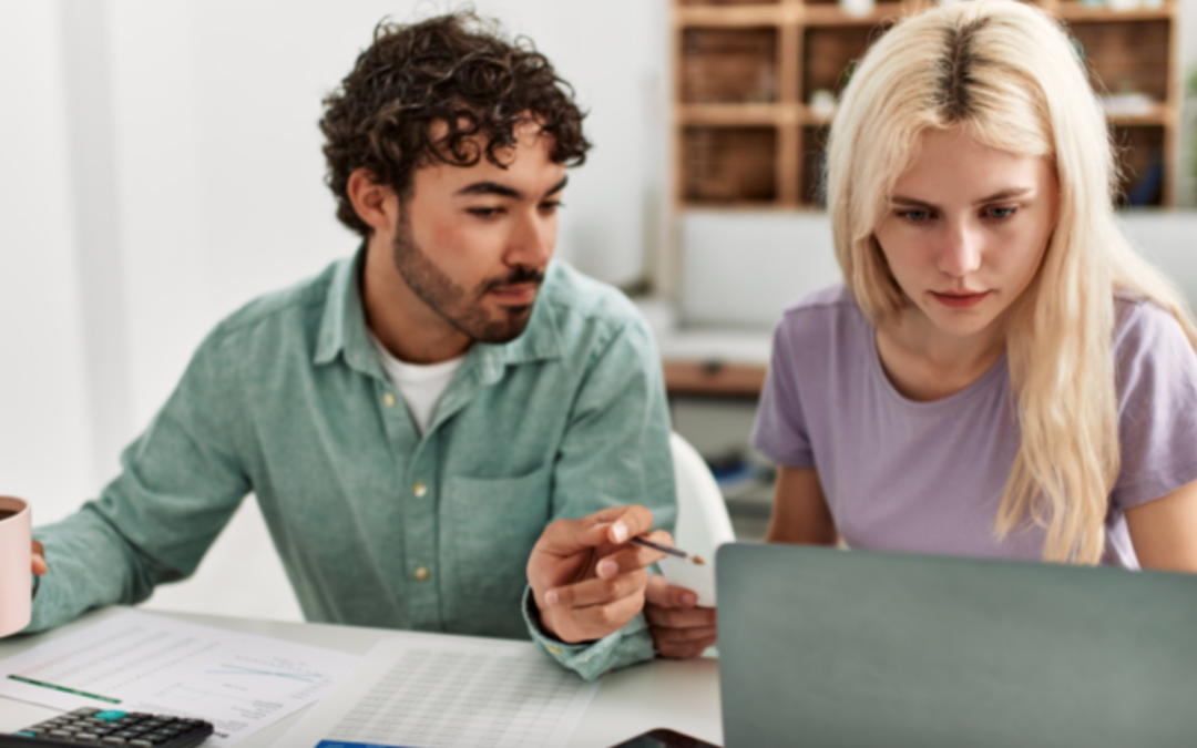 A man and woman using calculator and on computer researching options to cover cost of remodeling and upgrades to a home.